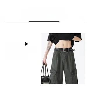 Detail of high-waist retro cargo pants featuring large side pockets and a black leather belt