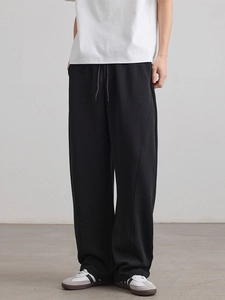 Men's loose black straight-leg sweatpants with drawstring waist and stitched seams