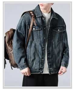 Detail of vintage washed denim jacket showing chest flap pockets and metal buttons