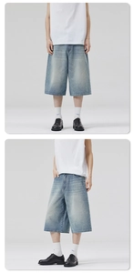 Detail view of baggy distressed denim shorts in light blue wash with vintage aesthetic