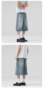Detail of light blue washed denim shorts showing the loose fit and back pocket design