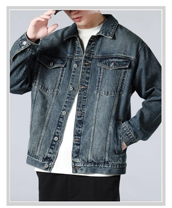 Close-up of vintage washed blue denim jacket with metallic buttons and chest pockets