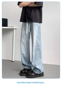 Close-up of light blue straight denim pants with elastic waist and white drawstrings