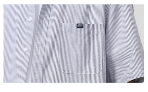 Detail of blue and white striped short sleeve shirt with chest pocket and small woven label