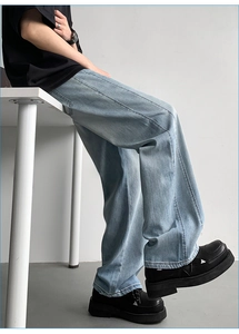 Close-up of light blue ice silk denim jeans with vertical stitching and wide leg cut