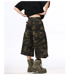 Rear view of camouflage cargo shorts with large flap pockets and a loose fit cut
