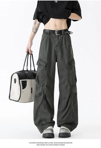 Detailed view of dark grey wide-leg cargo pants with multi-pockets and pleated street style