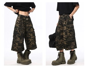 Detail of cargo pockets and woodland camo pattern on high street tactical shorts