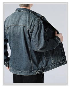 Detail view showing vintage washed denim jacket back stitching and inner fabric texture