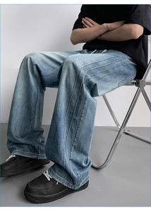 Detail view of light blue washed wide-leg jeans with unique triple-stitched side seams