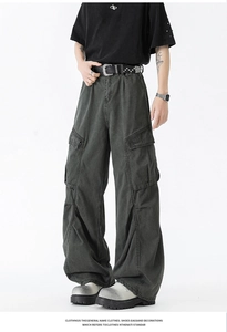 Detail of cargo pants showing side pockets and vintage loose fit in washed charcoal