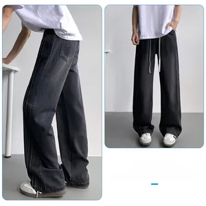 Detail showing dark grey wide-leg washed denim jeans with side stitching and drawstring