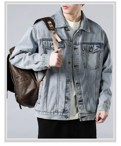 Detail of vintage washed light blue denim jacket with symmetric flap pockets for men