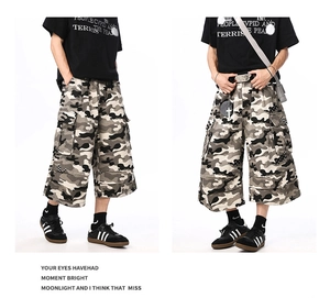 Detailed views of camouflage cargo shorts featuring large side utility pockets for street style