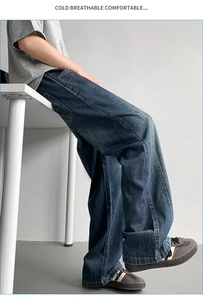 Detail view of deep blue wide-leg denim pants featuring reinforced contrast stitching