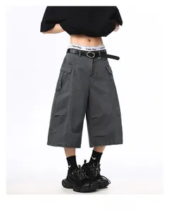 Detail of dark grey cargo shorts featuring large side pockets and heavy canvas texture