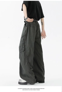Detailed macro view of heavy washed cotton cargo pants with side pockets and retro texture
