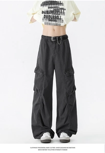 Detail view of retro wide-leg cargo pants with flap pockets and decorative metal chain