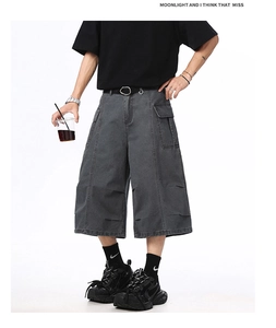Detailed close-up of dark grey cargo shorts featuring cargo pockets and distressed details