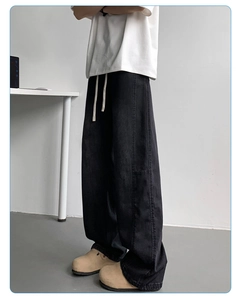 Detail of men's washed black ice silk denim jeans featuring elastic drawstring waist