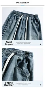 Detail of light blue denim trousers featuring elastic waist with white drawstring and side pockets