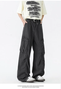 Close-up of retro wide-leg cargo pants with large flap pockets and woven leather belt
