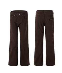 Detail view of dark brown leisure pants featuring metal rivet accents on the back pocket