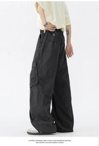 Detail view of black vintage cargo pants with side pockets and a relaxed wide-leg fit