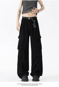 Detail of black cargo pants featuring flap side pockets and durable twill fabric textures