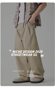 Detail of khaki wide-leg street style trousers with pleated design and relaxed silhouette