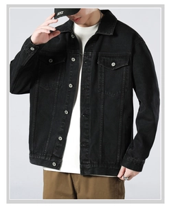 Detail view of a vintage washed black denim jacket with chest pockets and metal buttons
