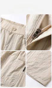 Detailansicht der khakifarbenen Hose mit Gummizug, AAK-Reißverschluss und Seitentaschen
