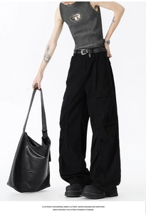 Detailed view of urban street style wide-leg cargo pants with large flap side pockets