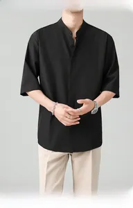 Detail view of black mandarin collar shirt with hidden placket and smooth anti-wrinkle fabric