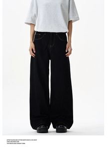 Detail of high-density black wide-leg jeans with vintage orange contrast stitching