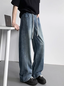Men's washed gradient blue lyocell denim jeans with vertical stitching and drawstring waist