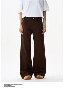 Detail view of high-waist wide-leg brown trousers in heavy cotton fabric with relaxed fit