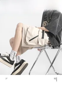 Detail of beige cargo shorts with large functional 3D pockets and side adjustment straps