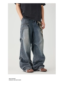Detail view of American vintage washed blue wide-leg jeans with distressed stitching details