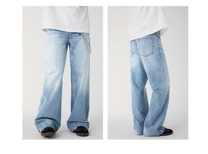 Detail of light blue washed straight jeans featuring a vintage look and metal waist chain