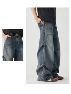Macro detail of vintage wash blue cargo denim pants featuring large utility pockets