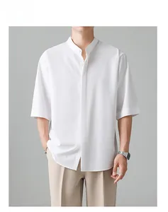 Male model wearing a white short-sleeve mandarin collar shirt with hidden buttons