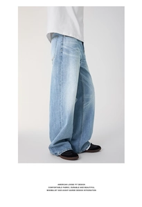 Detailed side view of American loose fit washed blue denim jeans with premium texture