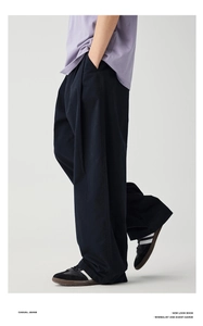 Detailed view of black wide-leg trousers featuring premium fabric texture and casual fit