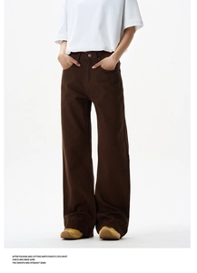 Detail of high-waisted dark brown wide-leg trousers in high street minimalist style
