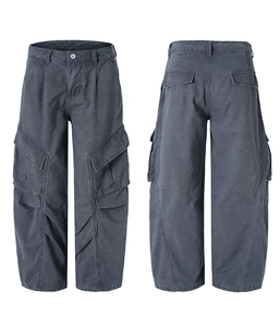 Detail of dark gray wide-leg cargo pants with 3D knee pleats and large flap pockets