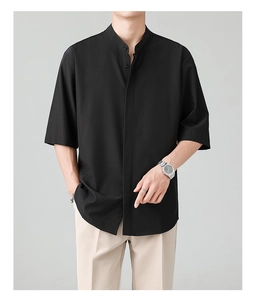 Close-up of a men's black oriental stand collar shirt with smooth silk-like fabric detail
