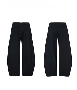 Front and back view of black wide-leg trousers with unique curved seams and minimal silhouette