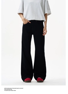 Detail of heavy twill fabric and loose-fit drape on black high street rivet leisure pants