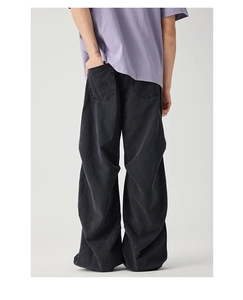 Rear view of vintage washed black oversized baggy denim jeans with stack effect detail
